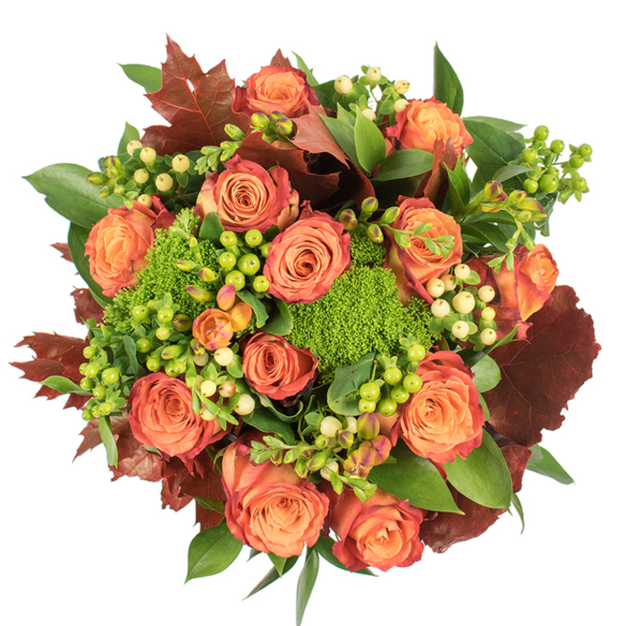 From directly overhead, this autumnal arrangement presents itself like a crafted map of seasonal colour: abundant roses in coral, peach, and deep orange form the primary language, each flower carrying a soft glow at its centre that graduates outward to russet-tinted outer petals. Interlaced with the roses are neat sprays of Hypericum berries-some a vivid lime, others a creamy, pale yellow-whose smooth, rounded forms act as lively counterpoints to the velvety rose blooms. Sprigs of Green Trick dianthus appear as plush, vivid-green clusters, their cushiony texture conjuring mossy garden corners and adding a sculptural, contemporary note. Deeper, rustic leaves in burgundy and reddish-brown are distributed throughout the circle, their lobed shapes reminiscent of late-season maple and oak, bringing depth and a quietly dramatic autumnal cadence. A tapestry of glossy and matte greens underpins the arrangement, creating a sense of fullness and natural ease. The lighting is soft and diffuse against a white background, which lifts the warmth of the corals and oranges and sharpens the greens, making each element distinct yet harmoniously integrated. This bouquet is ideal for Thanksgiving or a cosy gathering, and reflects the mindful craftsmanship of a neighbourhood florist-Eastcote Florist prepares similar designs for delivery across Eastcote High Street, Field End Road and surrounding lanes-celebrating comfort, gratitude and the tactile pleasures of late-season blooms.